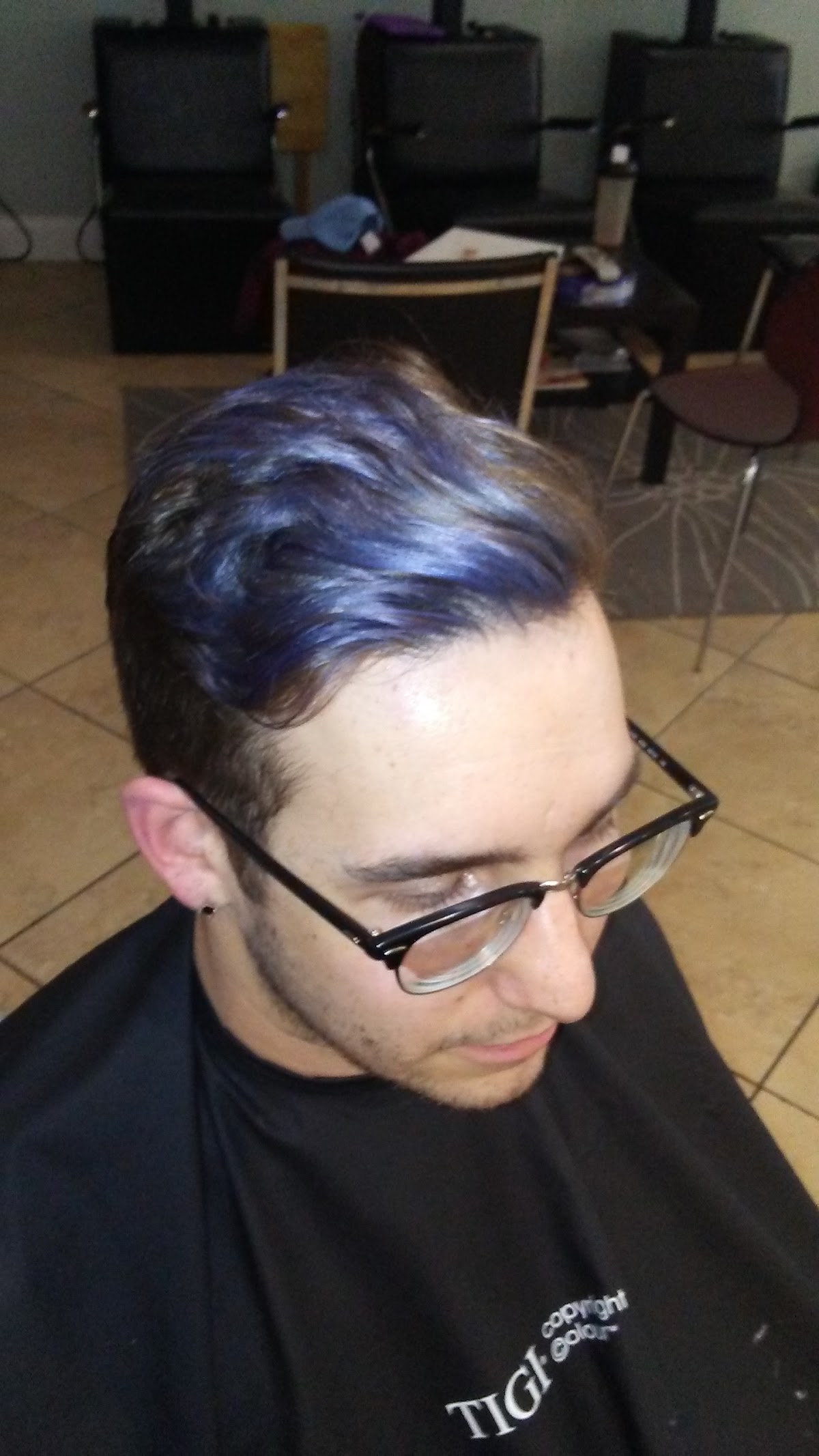 Bold blue color work blended into a men's cut at Salon La Vie