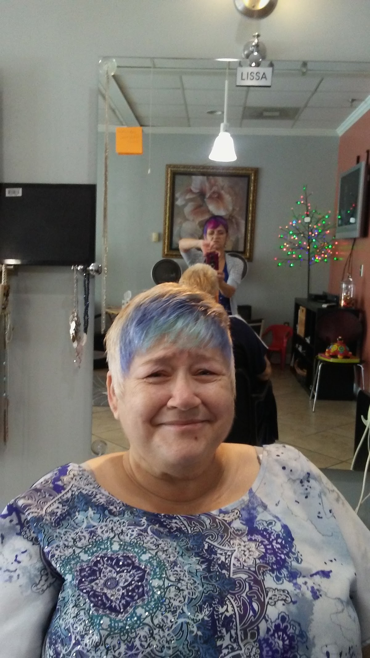A happy Salon La Vie client with freshly styled color at Lissa's station